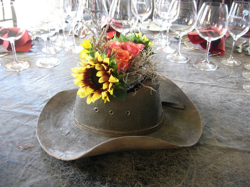 Use a cowboy hat as a vase for your reception table centerpiece flowers ...