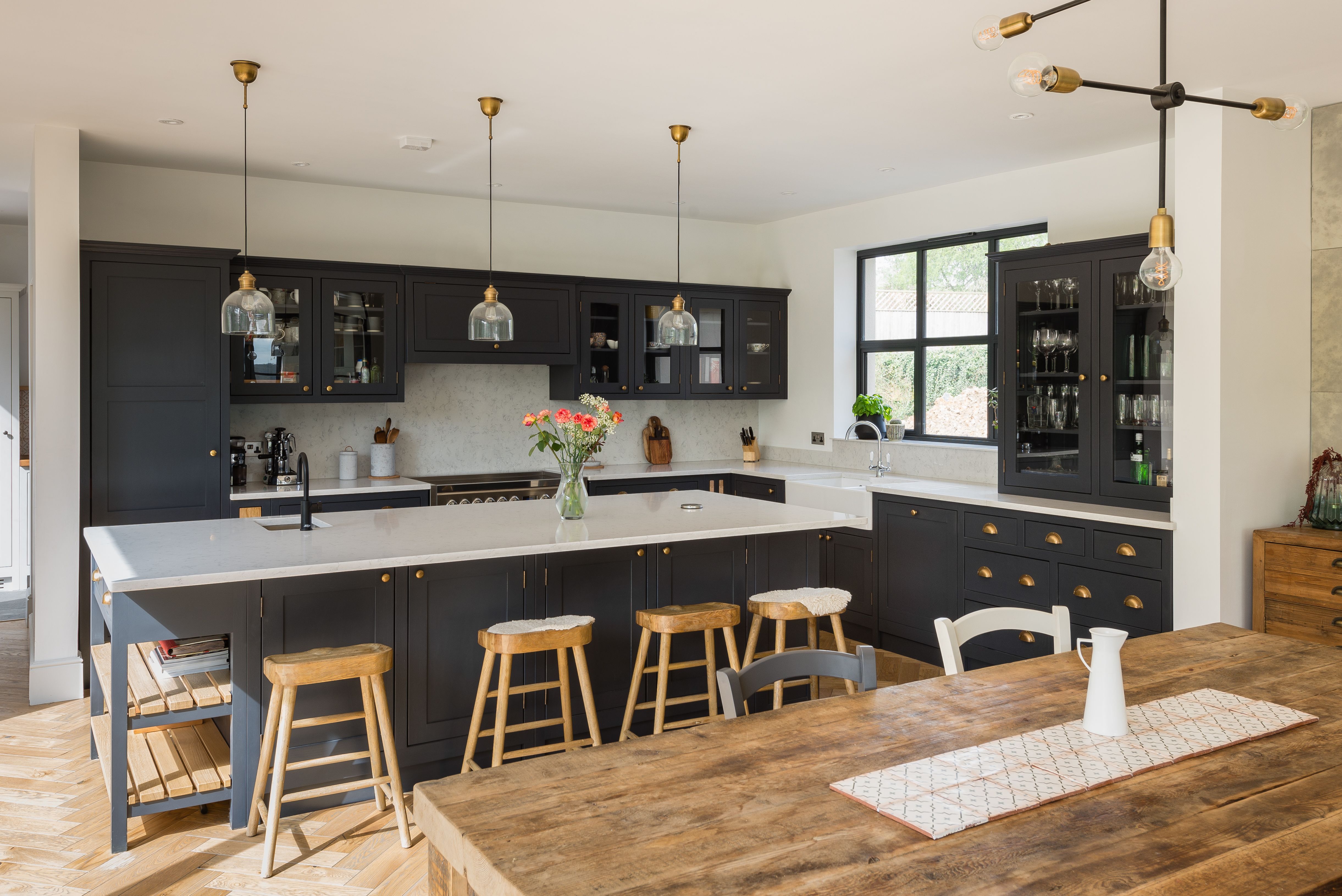 A large kitchen island in a Shaker kitchen. Open plan kitchen living