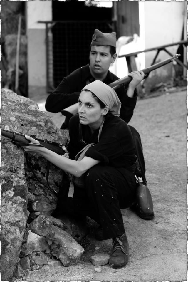 Two brothers militians expect the enemy hiding behind a low wall. # ...