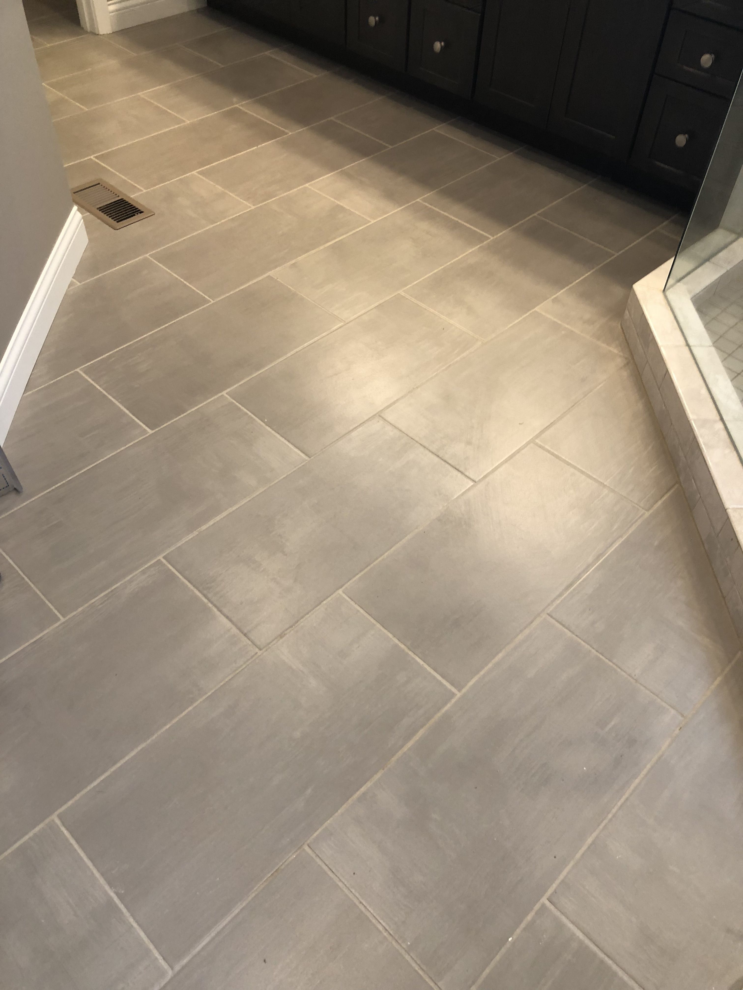 SKYBRIDGE 12X24 GRAY FLOOR TILE INSTALLED BRICK JOINT Bathrooms