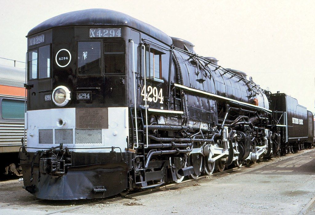 an old train is parked on the tracks