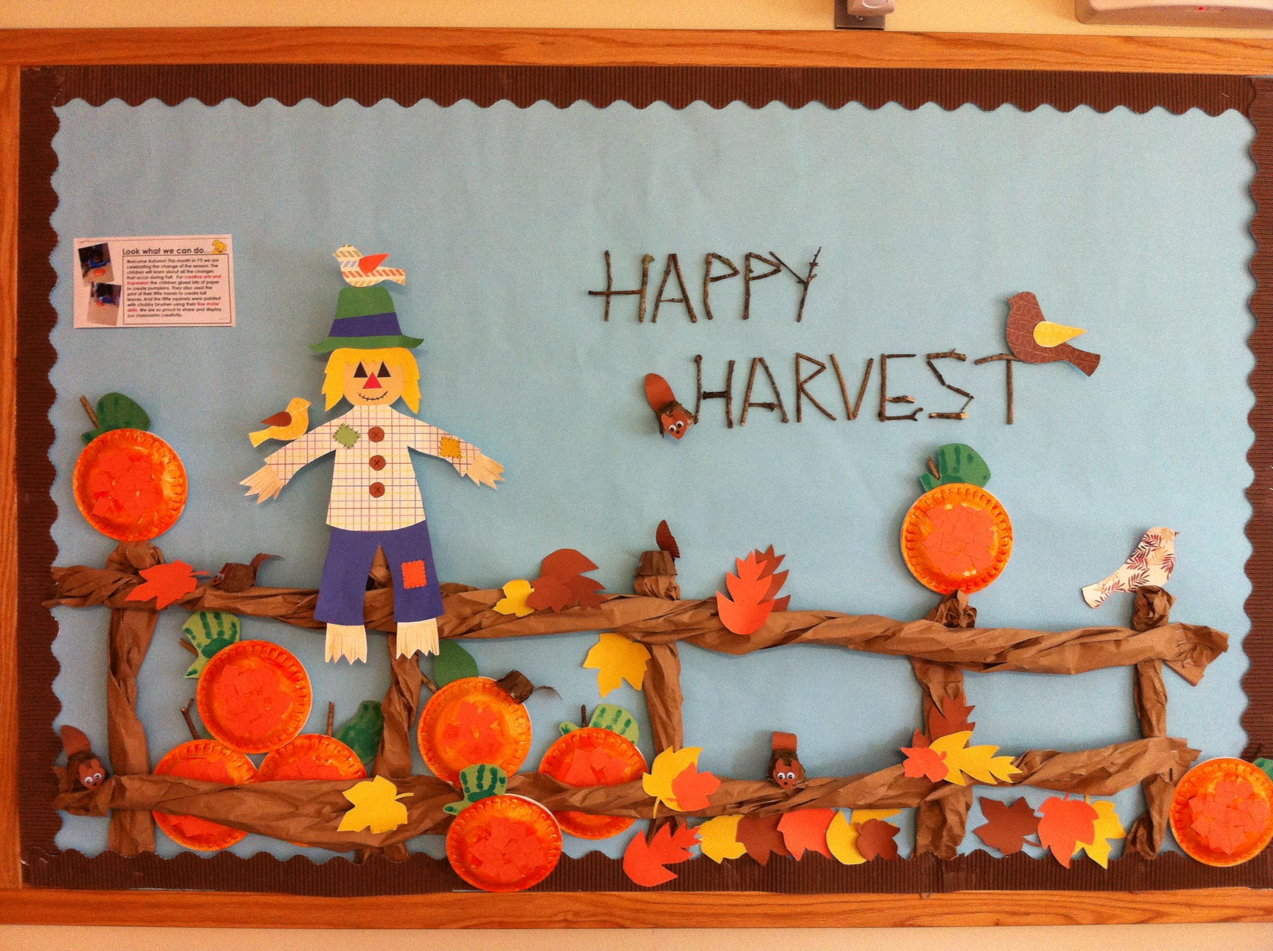 a bulletin board with an image of a scarecrow and pumpkins on it that ...