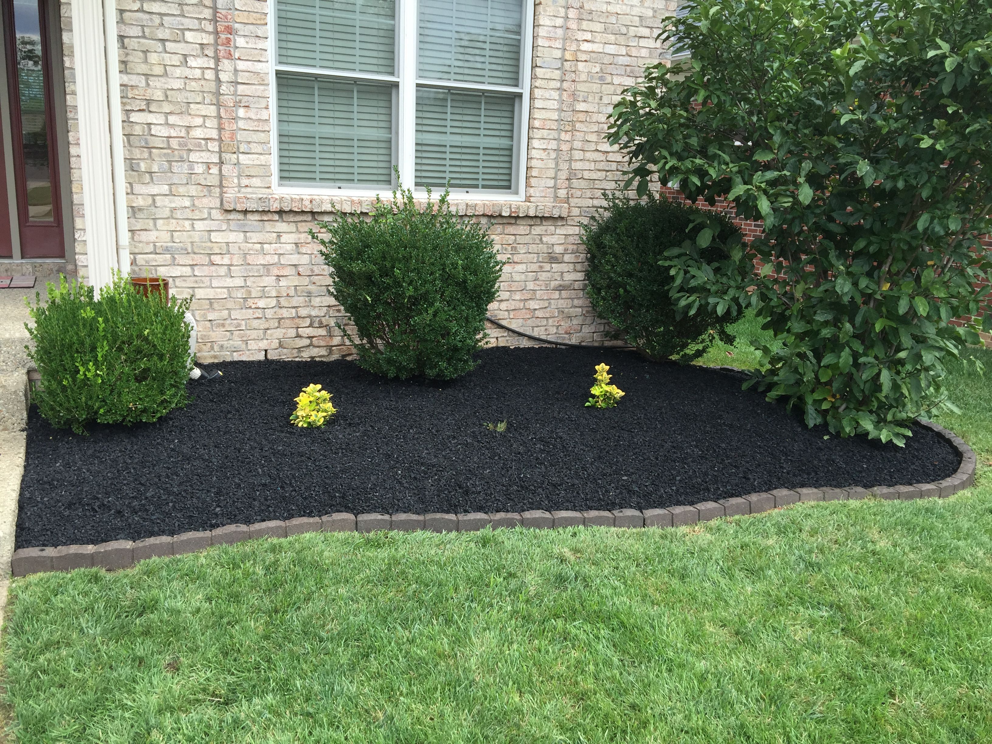 Image of Black rubber mulch in a garden bed