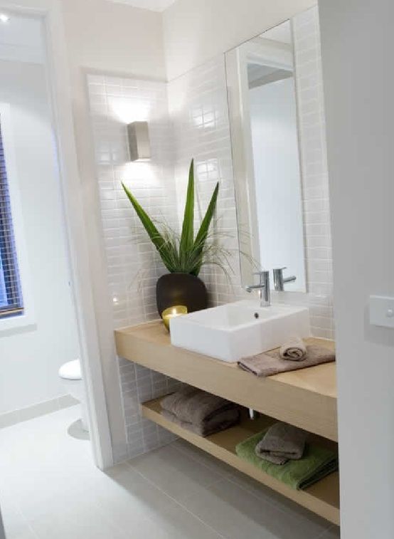 toilet divider wall, sink area, white small tiles, light