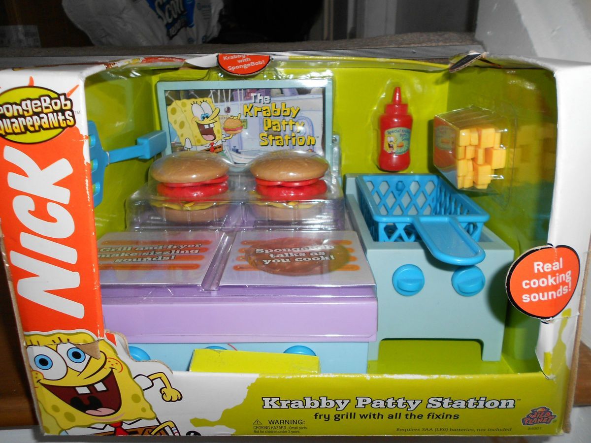 a toy kitchen playset with hamburgers and ketchup