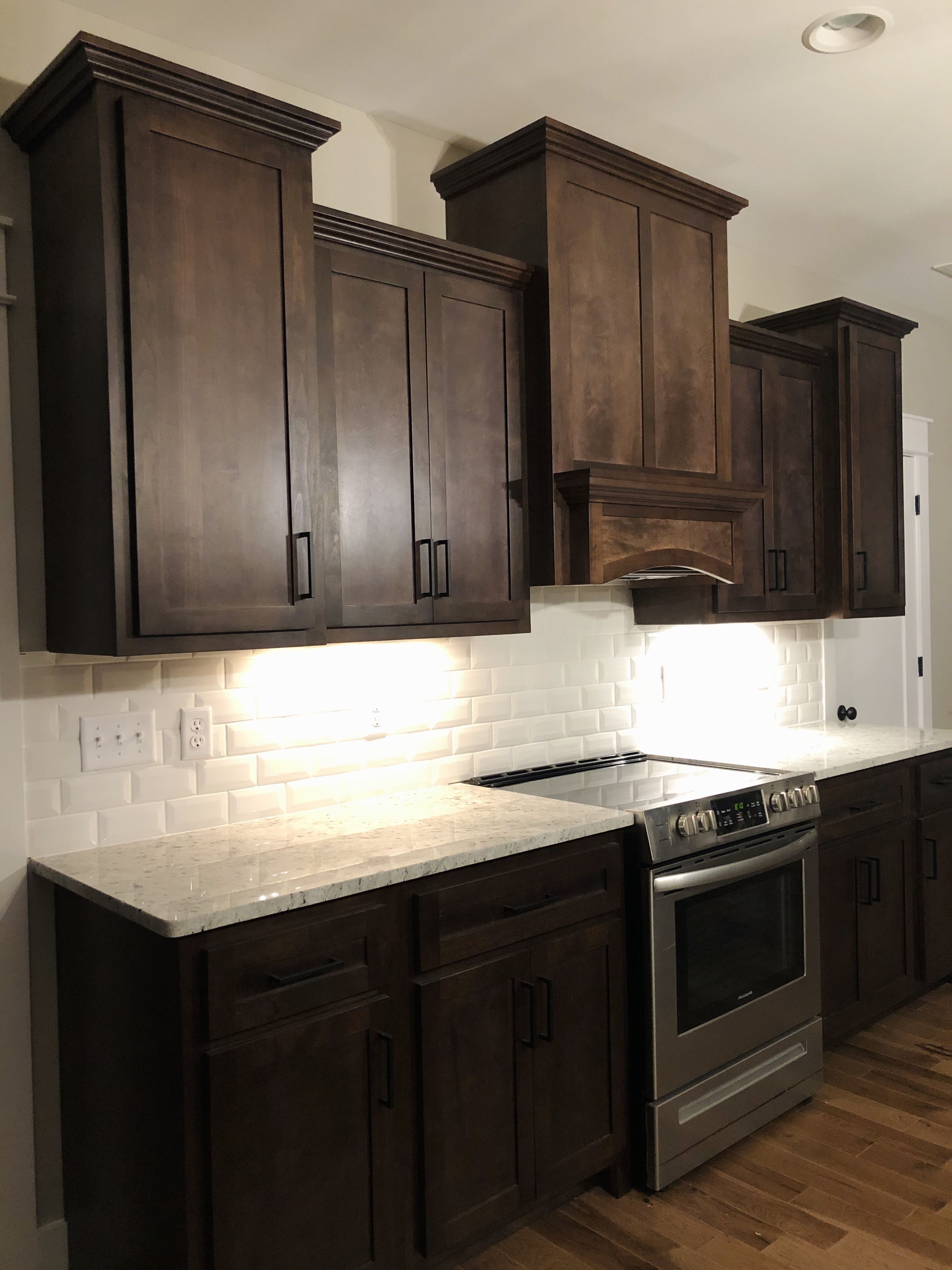 Dark kitchen with white backsplash Dark brown kitchen