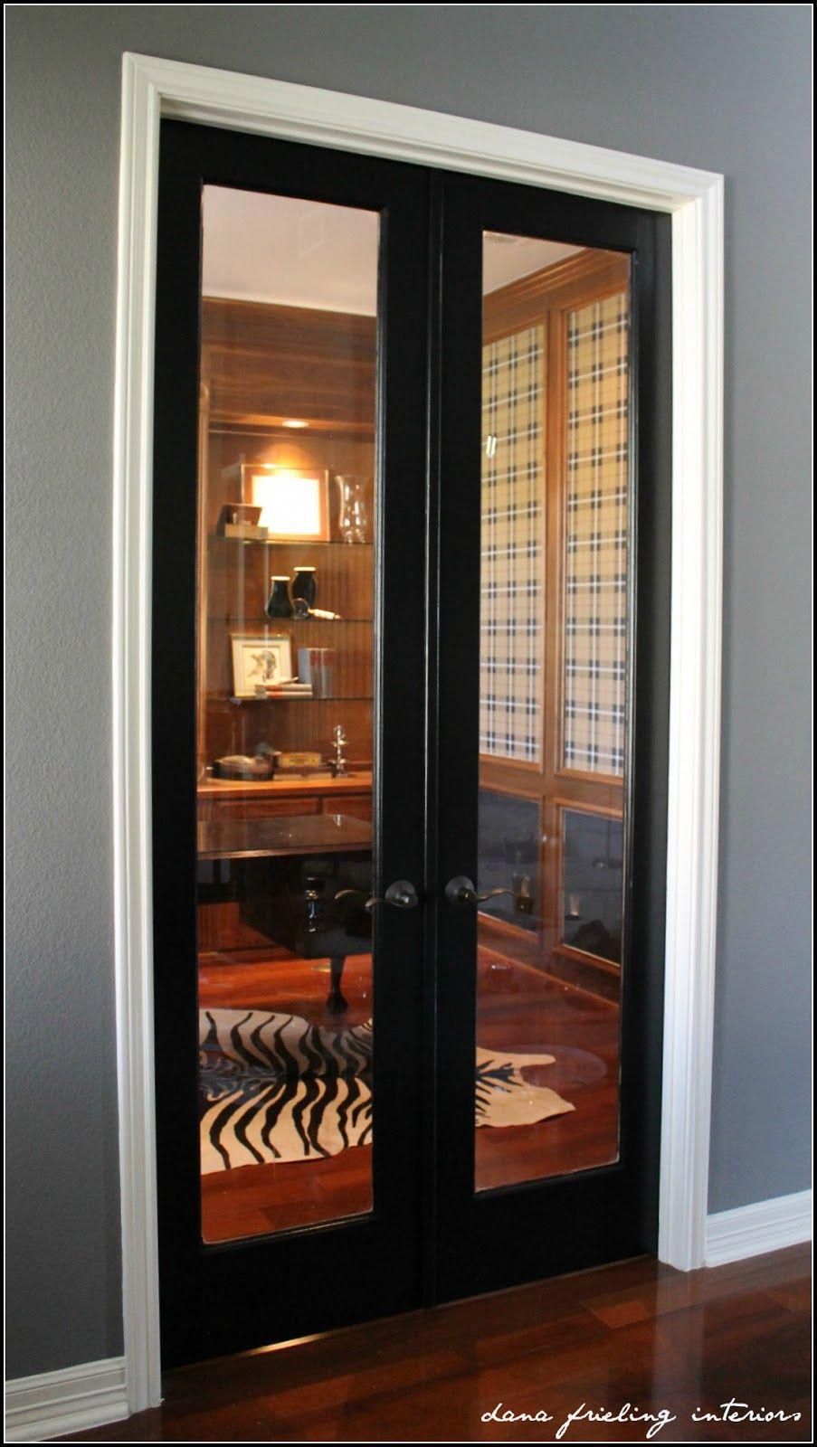 black door with white trim, grey walls and dark floors! French doors