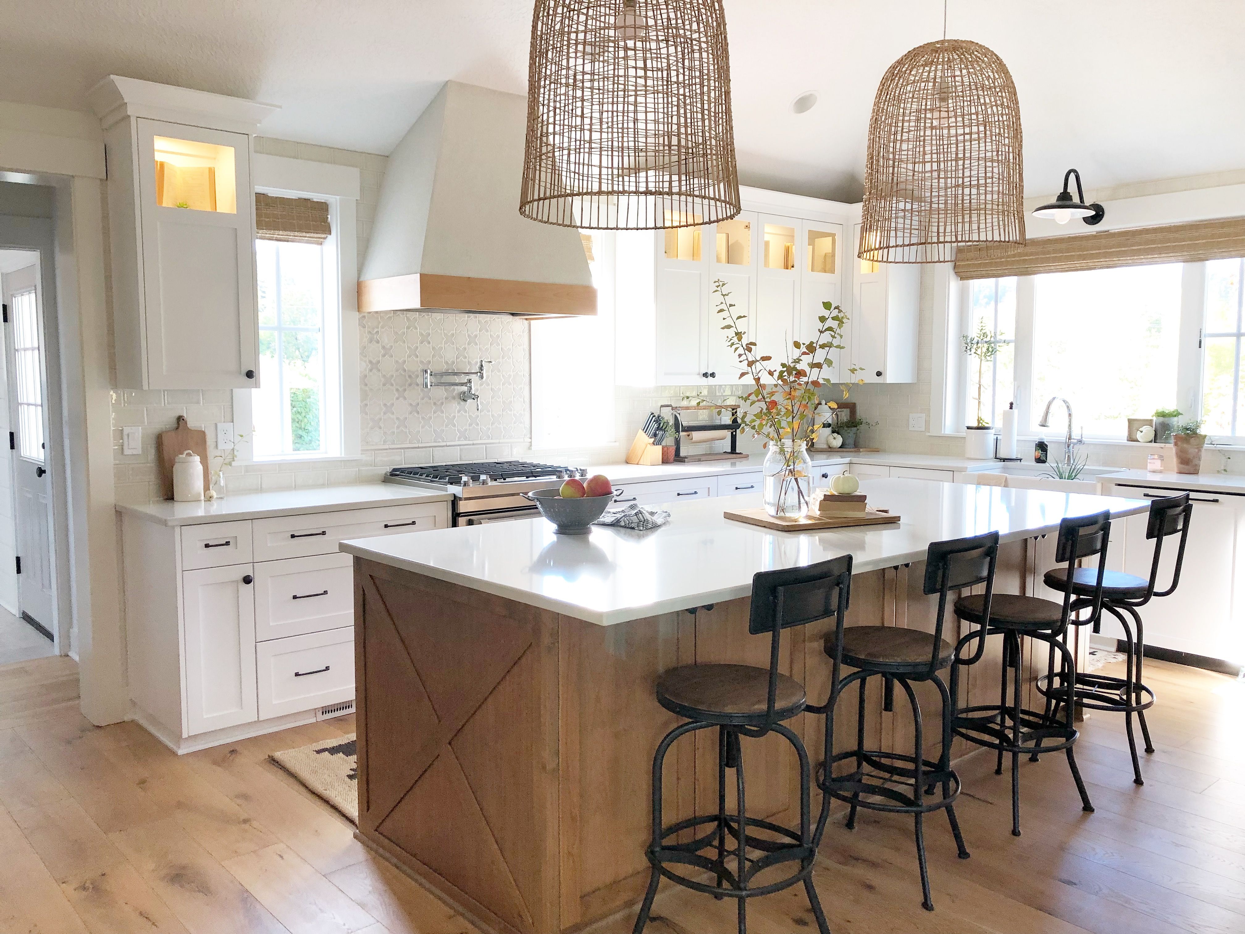 A stained island provides contrast in this white farmhouse kitchen