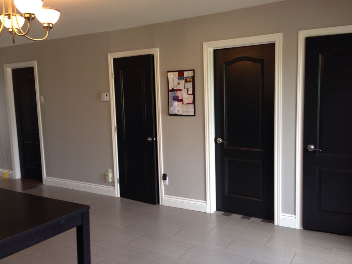 Dark doors with white trim it on grey walls. Inspirations http//www