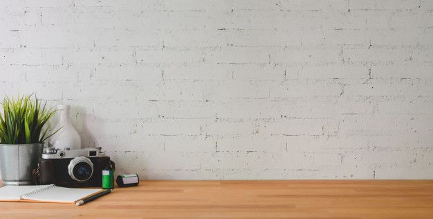 Premium Photo | Cropped shot of comfortable workplace with camera and office  supplies on wooden table and brick wall | White desk background,  Comfortable workspace, Marble desk