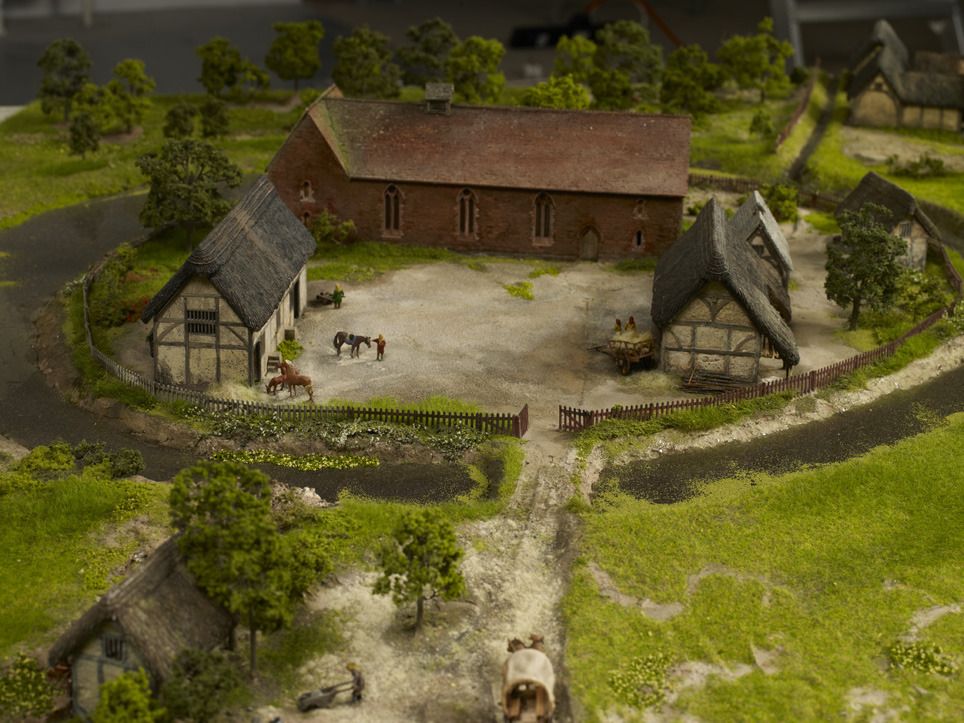 a small model village with horses and buildings