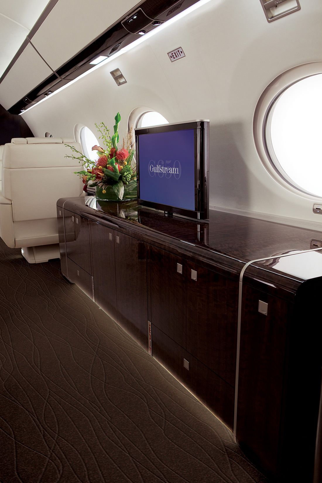 the inside of an airplane with a flat screen tv on it's side shelf