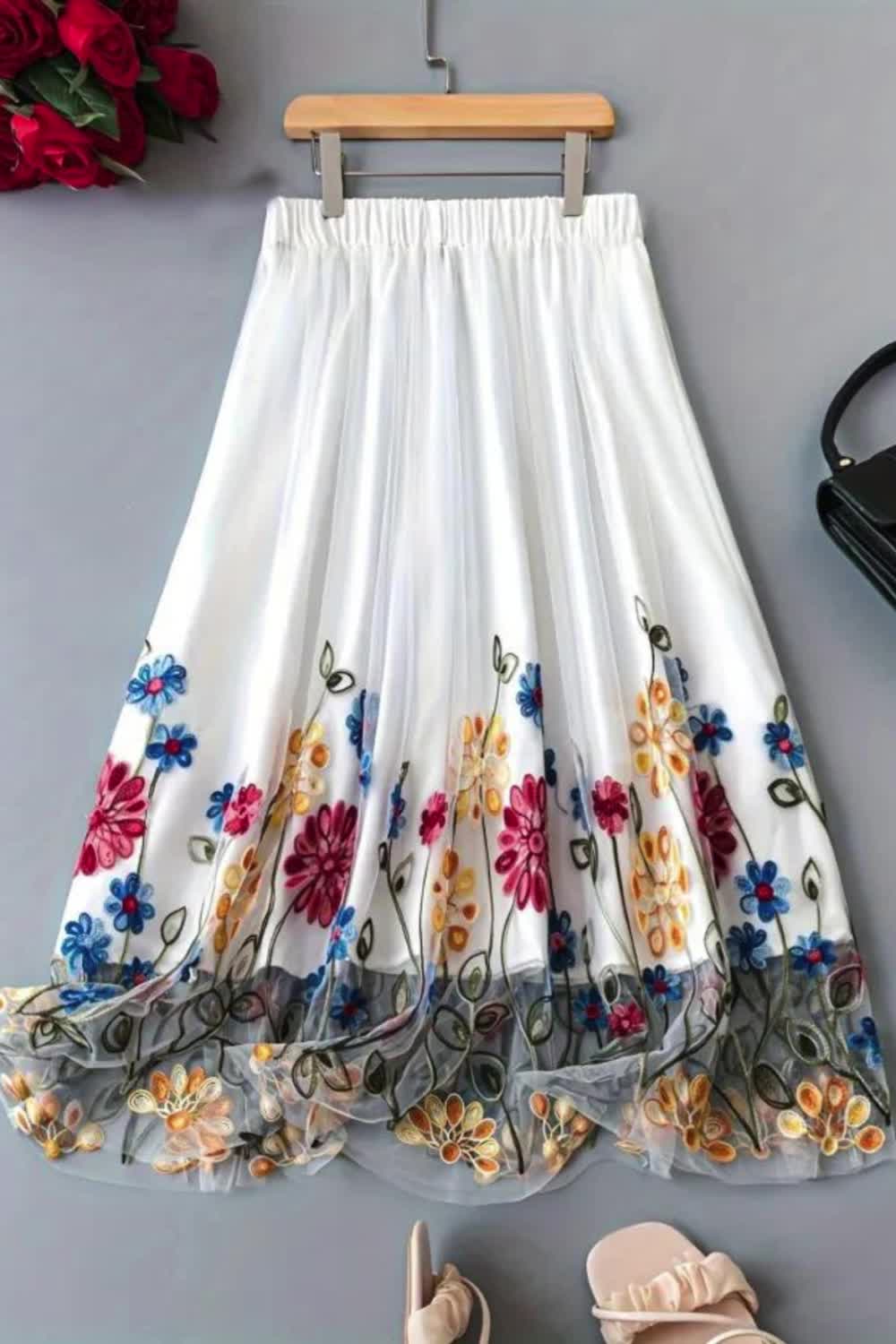 Embrace the allure of spring and summer in this elegant high-waist A-line skirt adorned with delicate floral embroidery on mesh fabric. Effortlessly chic, it offers a perfect balance of femininity and sophistication, ideal for adding a touch of romance to your warm-weather wardrobe.