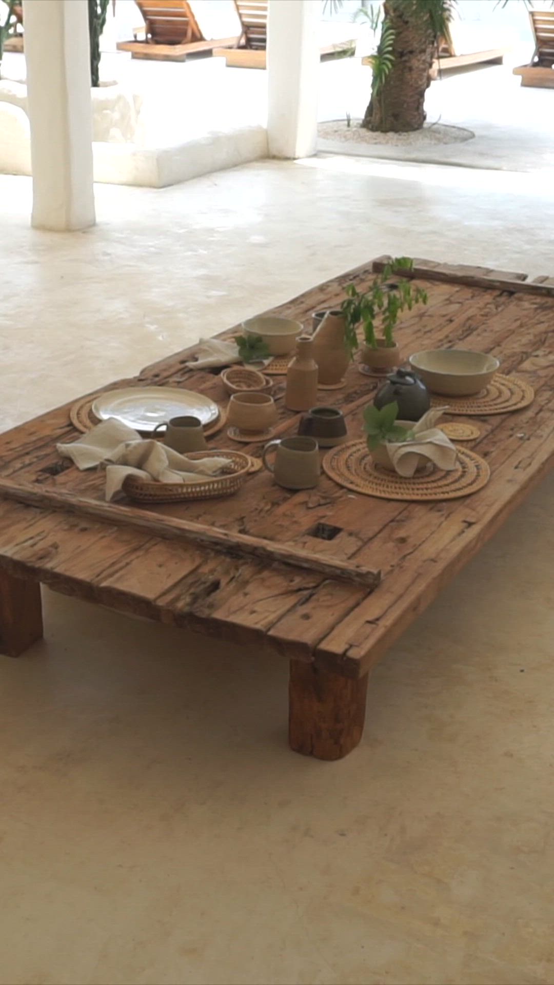 This may contain: a table with plates and bowls on it in the middle of an open floor plan