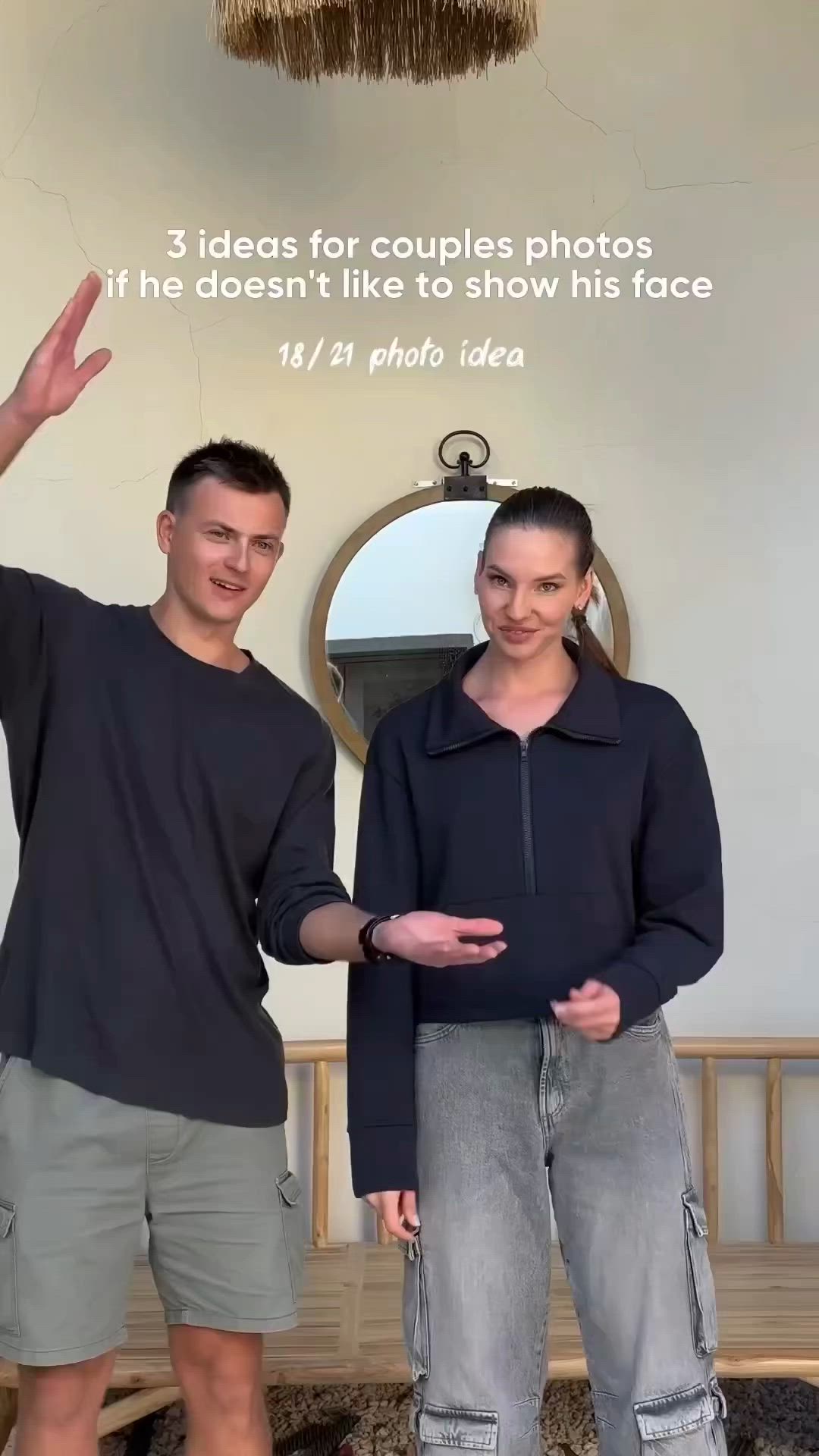 This may contain: a man and woman standing in front of a mirror with their hands up to the camera