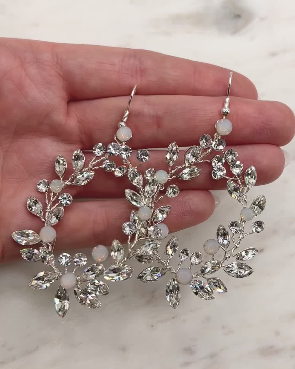 Make the ultimate grand entrance with our Lexie Floral Statement Earrings. Delicately crafted with opals and crystals. Lightweight for easy day to night wear. Crystal and opal gemstones Measures 3" x 1.5" Pair with our matching Lexie Floral Bracelet Hypoallergenic, lead-free & nickel-free Style #4189