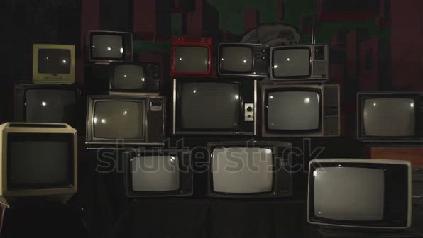 This may contain: several televisions with green screen are stacked on top of each other in front of a black background