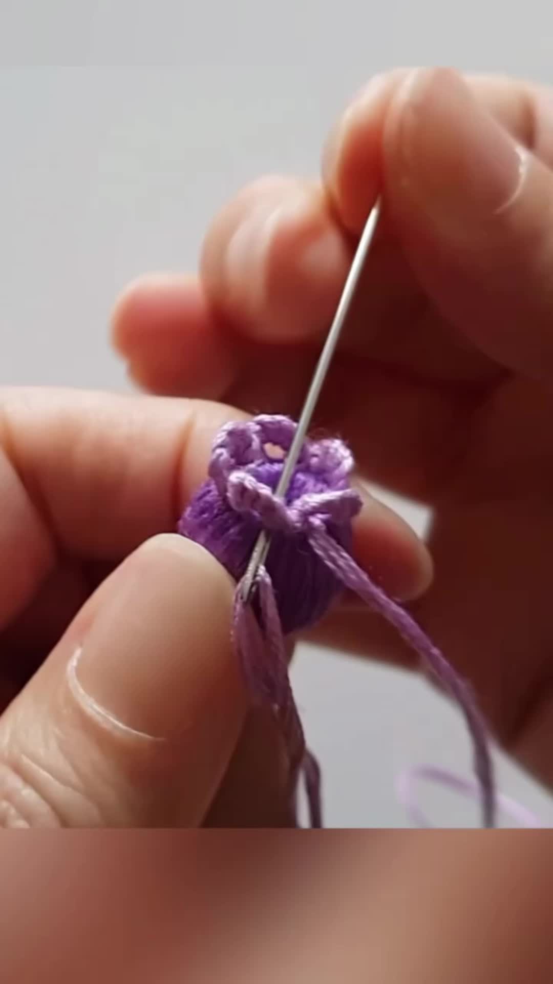 This may contain: someone is knitting something with their fingers