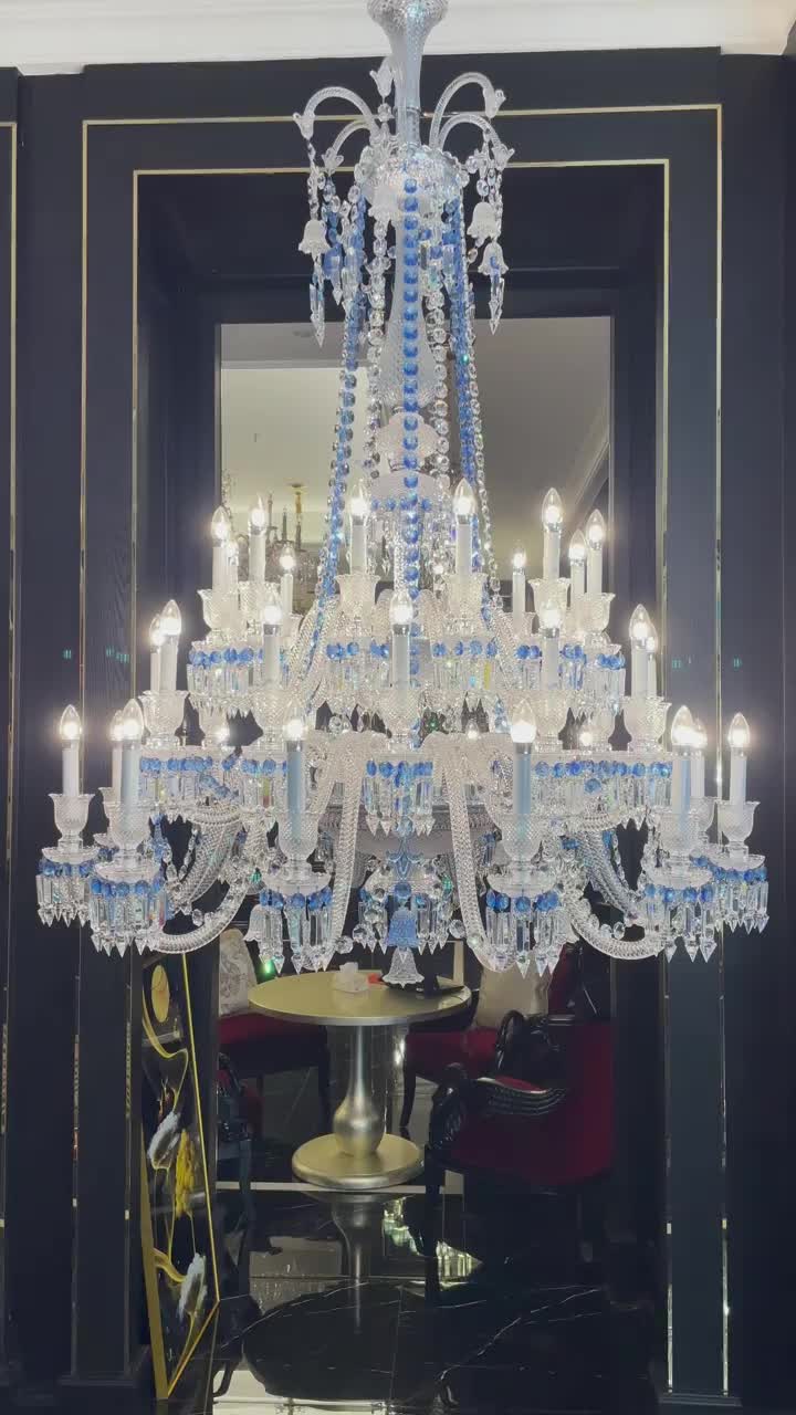 This may contain: a chandelier hanging from the ceiling in a room