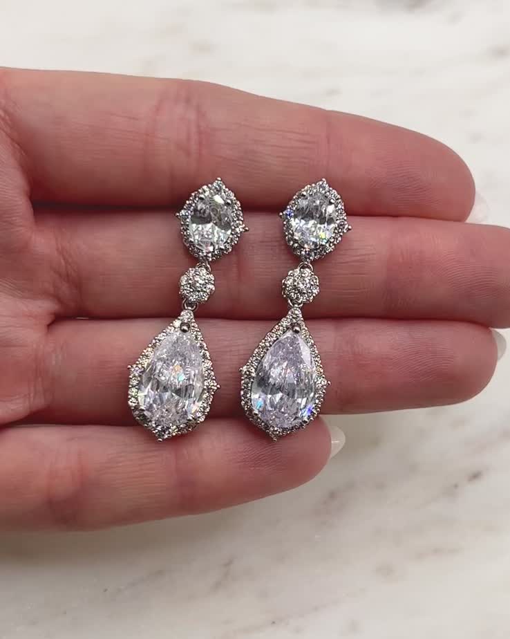 Perfect for adding vintage inspired beauty to your wedding look, our Emerson CZ Earrings are designed with CZs that sparkle like real diamonds. Model is wearing silver. Cubic zirconia Measures 1.5" in length Hypoallergenic, lead-free & nickel-free Style #4095