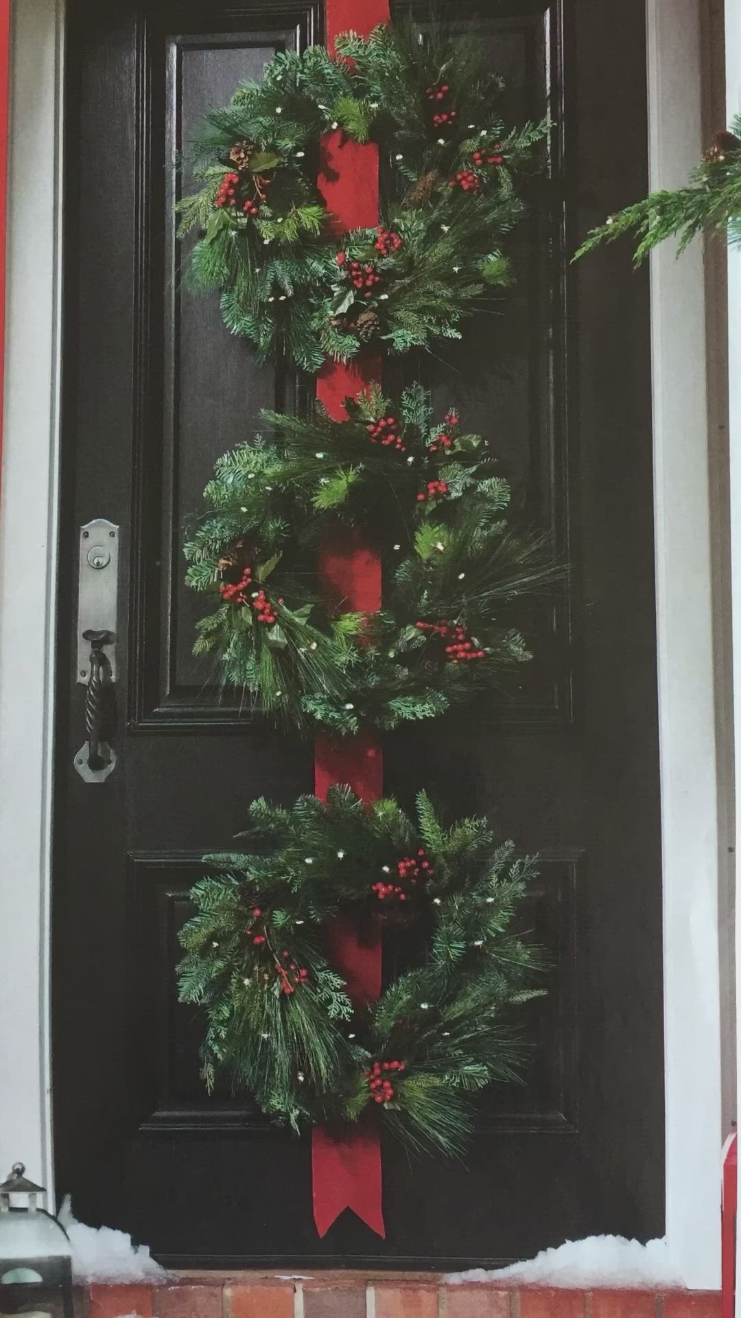 This may contain: a christmas wreath is hanging on the front door