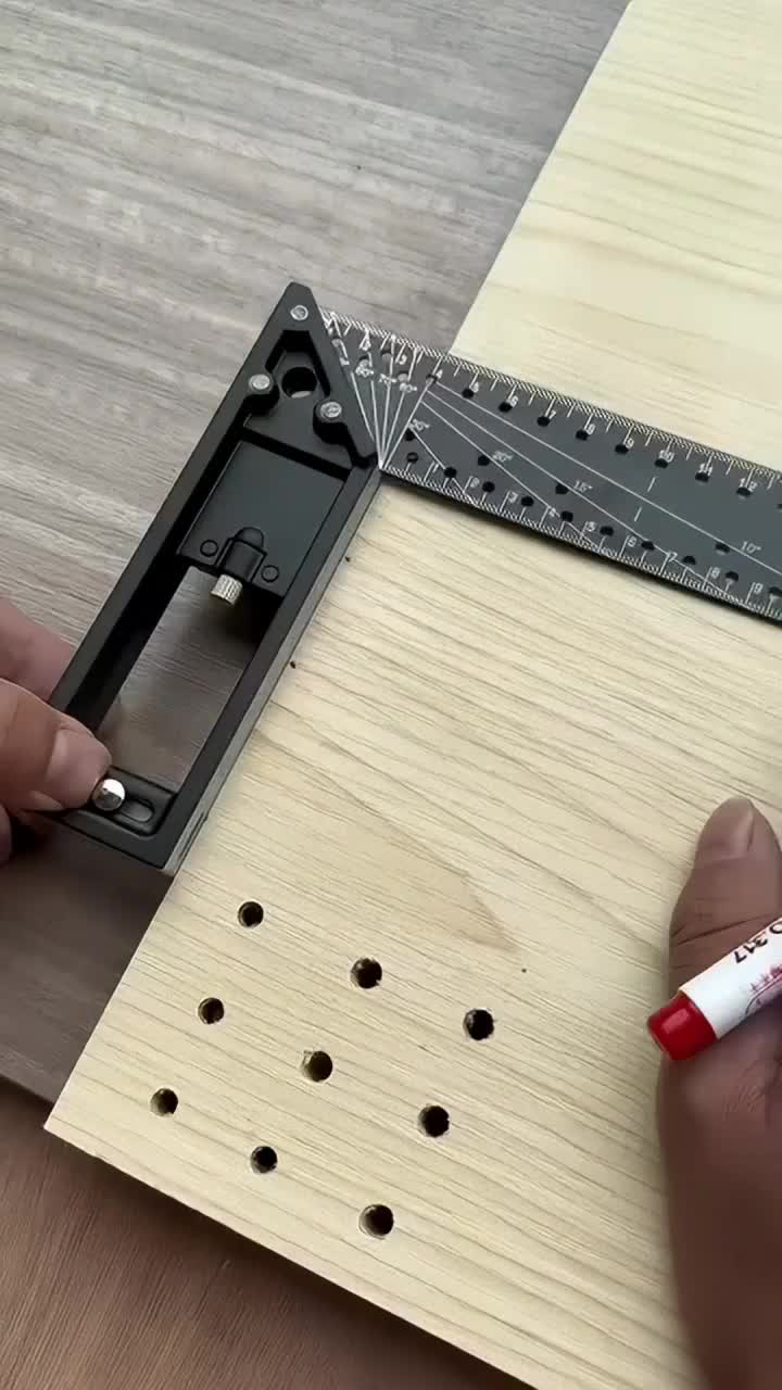 This may contain: a person is using a ruler to make holes in the wood for a piece of furniture