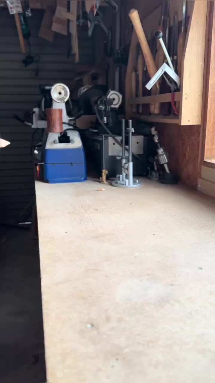 This may contain: a person working on a wooden table in a garage