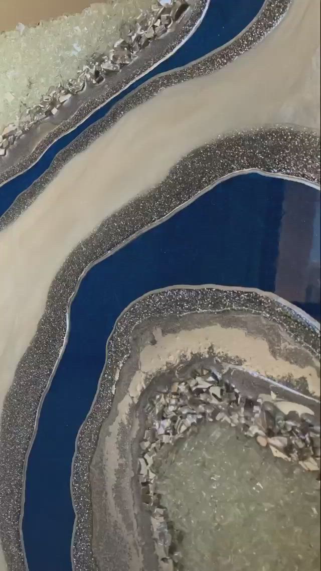 This may contain: an aerial view of a river running through a sandy area with blue water and sand