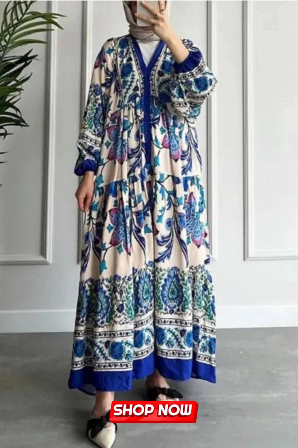 This maxi dress showcases ethnic-inspired prints in contrasting colors, embracing a stand collar and long sleeves for a chic appeal. The fusion of vibrant hues and cultural motifs creates a stunning ensemble, perfect for those seeking a unique, elegant style in their wardrobe.