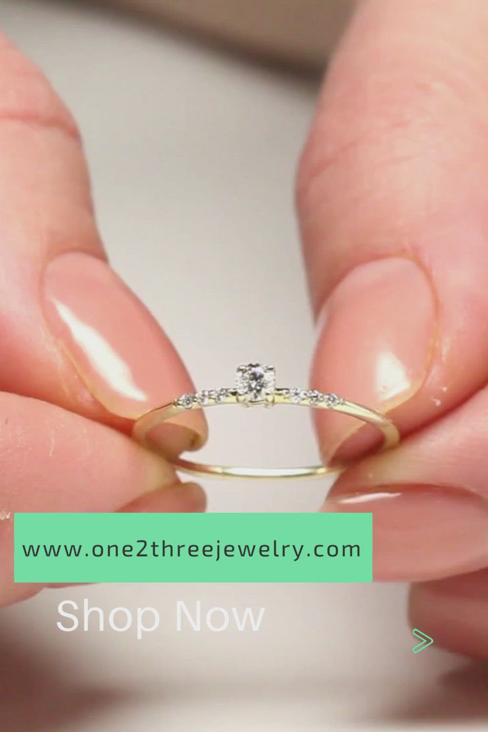 This contains: simple promise ring in yellow gold with diamonds in women's hands