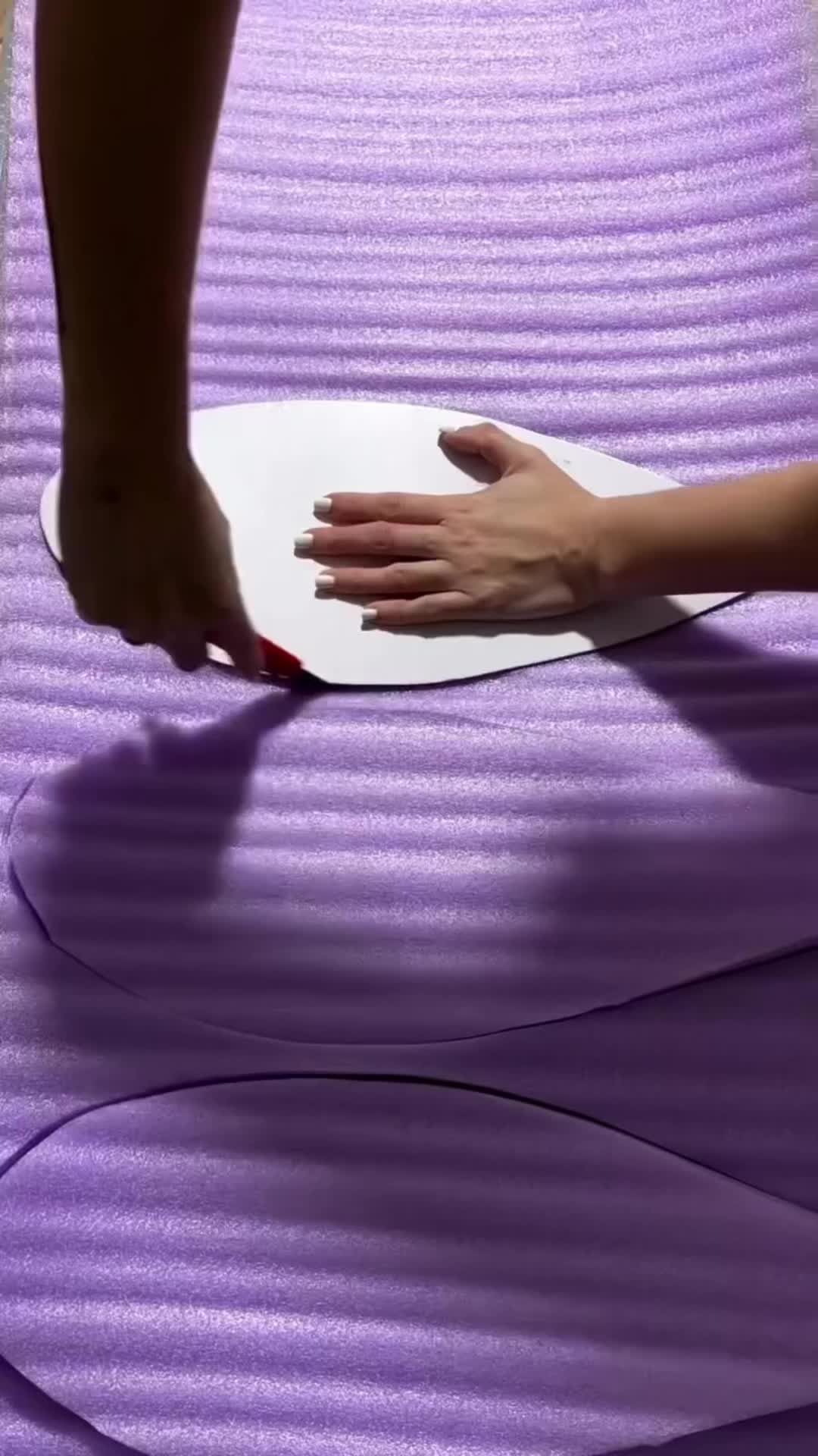 This may contain: a person with their hand on top of a yoga mat