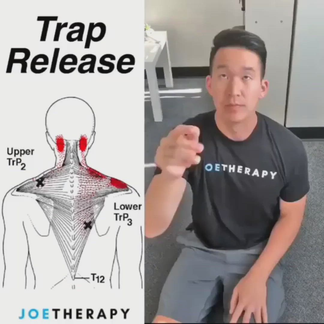 This may contain: a man is sitting down and pointing at the back of his shirt that says trap release