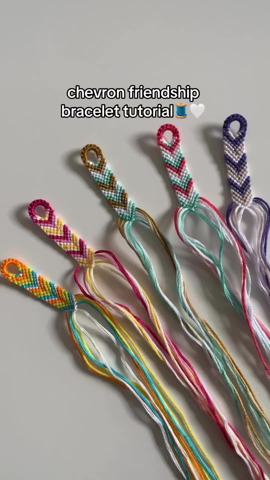 This may contain: several braided bracelets sitting next to each other on top of a white surface