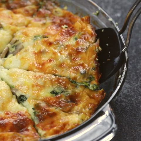 This may contain: a casserole with broccoli and cheese in a pan on a table