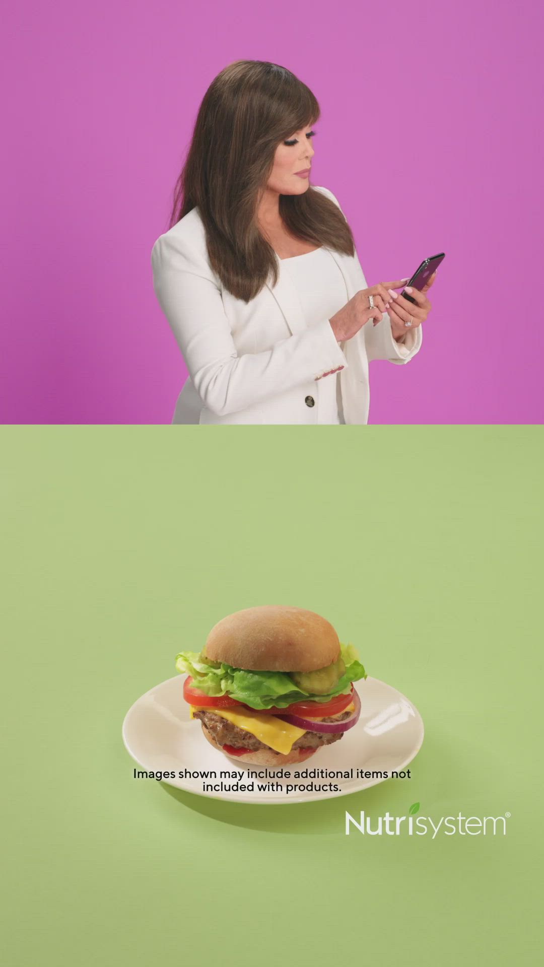 This may contain: a woman looking at her cell phone while she is holding a sandwich on a plate