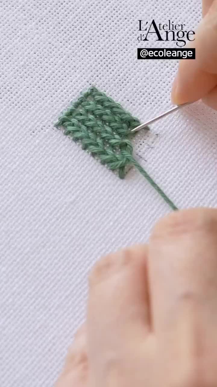 This may contain: someone is crocheting the stitches on a piece of fabric