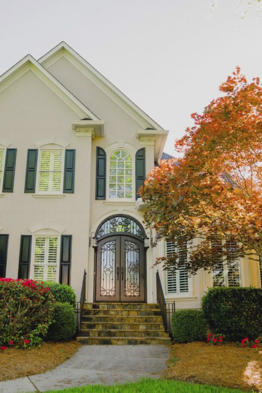 This may contain: the front door to a home with wrought iron doors