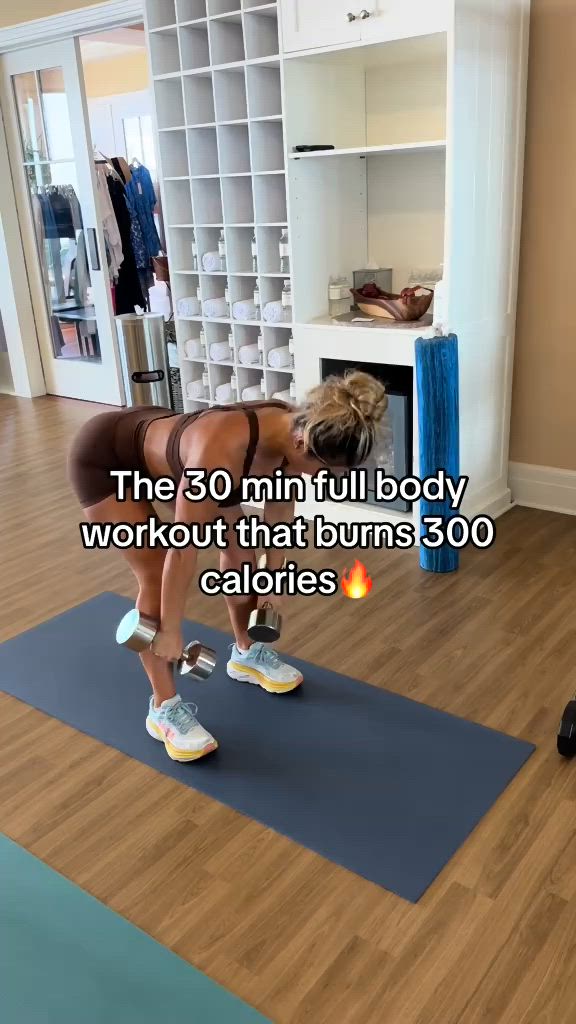 This may contain: a woman is standing on a yoga mat in the middle of a room with a kettle