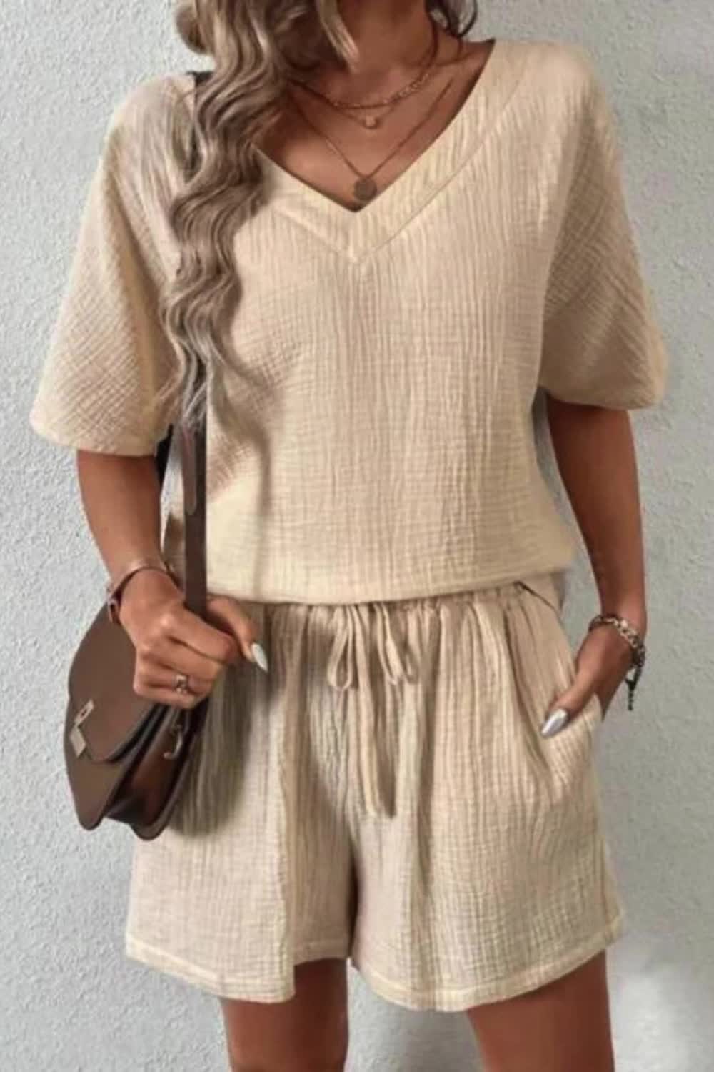 "Stay effortlessly chic with our Women's Summer V-Neck Casual Loose Two-Piece Set. This comfy set features a relaxed V-neck top and matching loose-fit shorts, perfect for summer days."