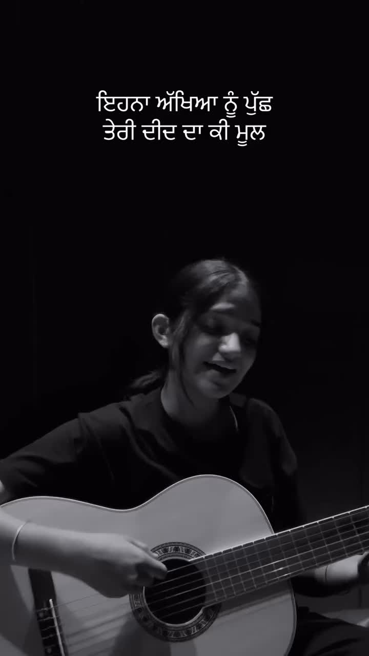 This may contain: a woman playing an acoustic guitar in front of a black background with the words,