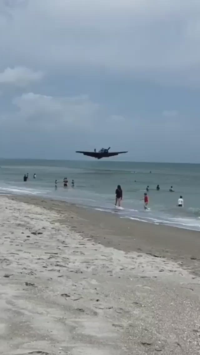 This may contain: an airplane is flying over the beach with people