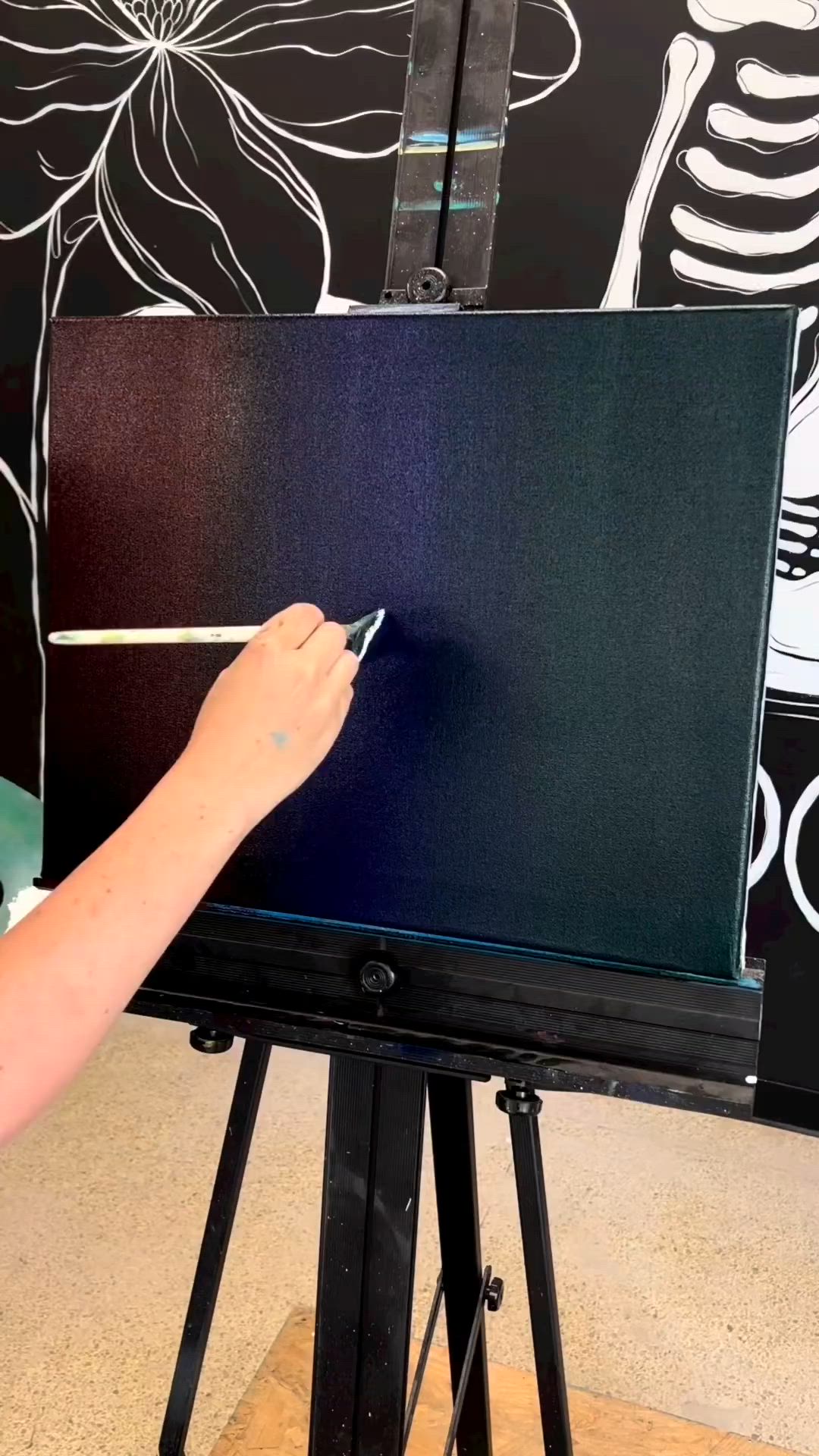 This may contain: someone is painting an image on the easel