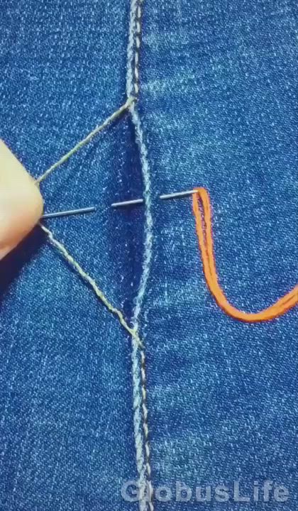 This may contain: a pair of scissors that are in the back pocket of a jean jacket with stitching