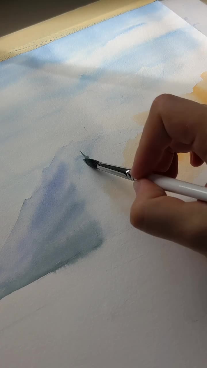 This may contain: a person is painting on an easel with watercolors