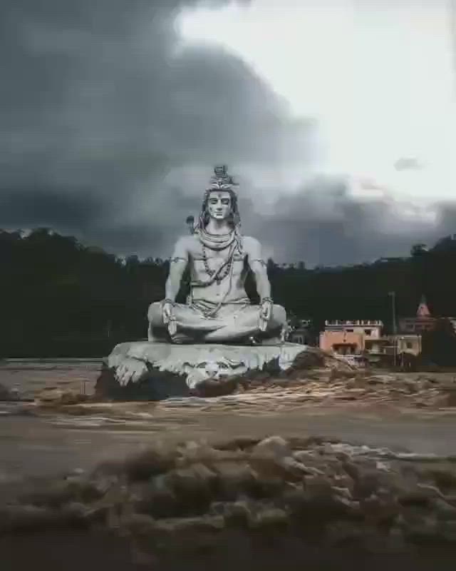 This may contain: there is a buddha statue in the middle of a body of water under a cloudy sky