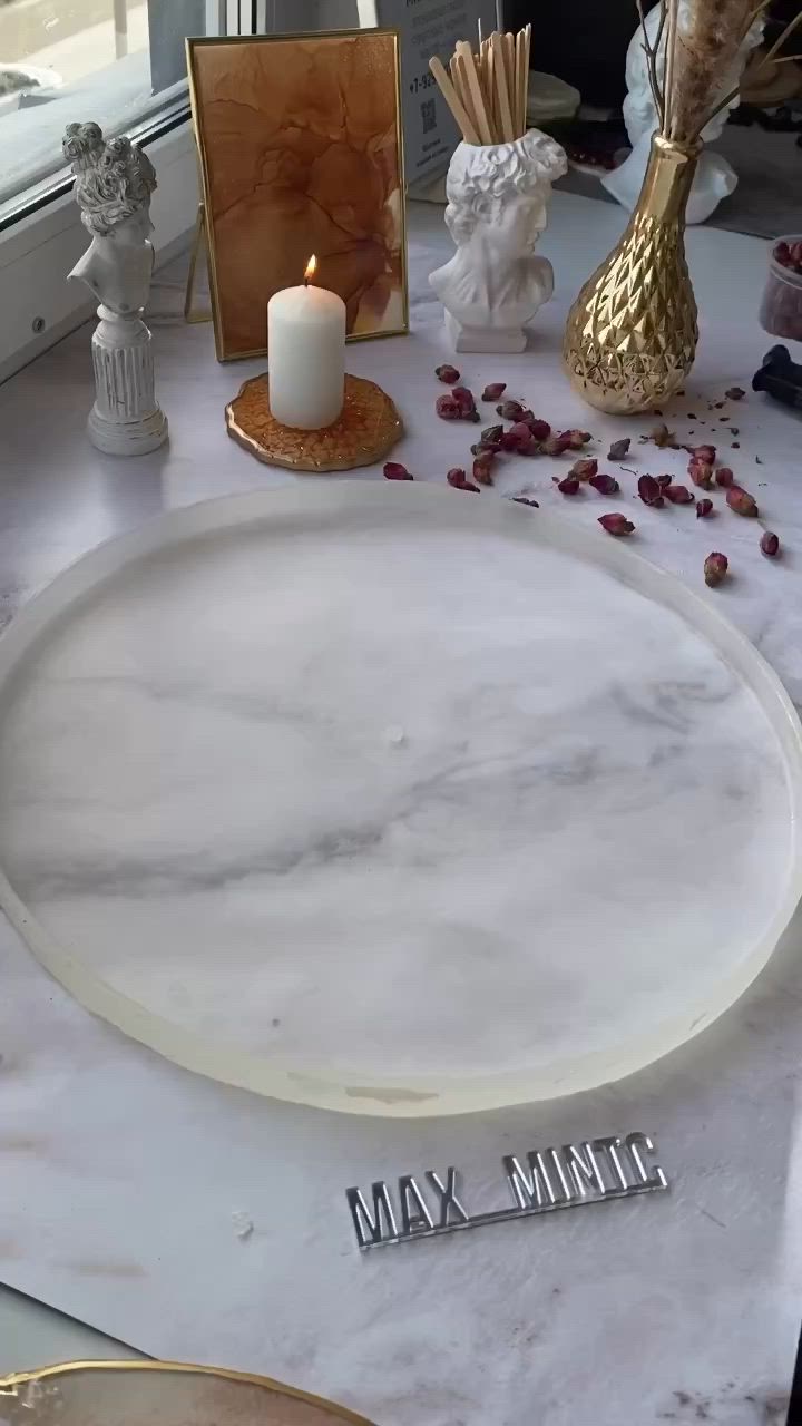 This may contain: someone is decorating a table with white marble