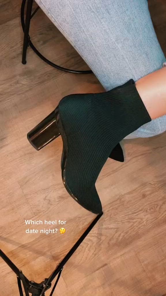 This contains: Women wearing Pashion Footwear's convertible black knit ankle bootie. Women changes heel from a black block to a transparent block to a gold chrome block so that the boot can be worn in different settings and with different outfits.