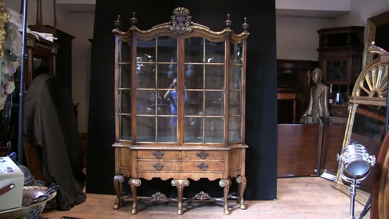 This may contain: an old wooden china cabinet with glass doors