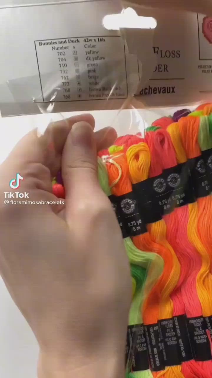 This may contain: a person is holding some yarn in their hand