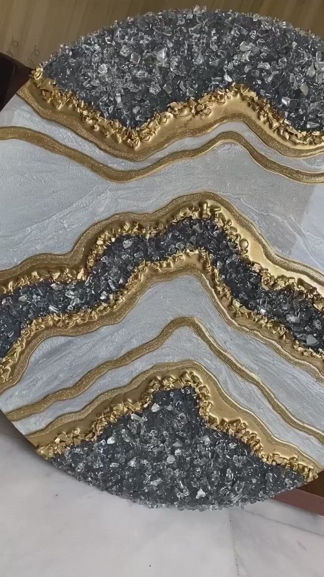 This may contain: a white and gold plate sitting on top of a table next to a wooden box